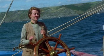 Movie still from “Carrington” (1995), directed by Christopher Hampton – A woman standing at the wheel of a boat on the water; Medium shot, High angle