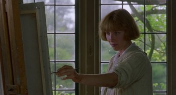 Movie still from “Carrington” (1995), directed by Christopher Hampton – A woman is painting a picture in front of a window; Medium shot, Low angle