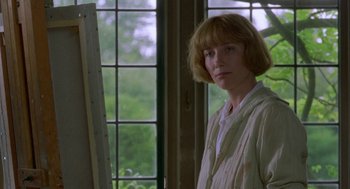Movie still from “Carrington” (1995), directed by Christopher Hampton – A woman standing in front of an easel in front of a window; Close Up shot, Over the shoulder angle
