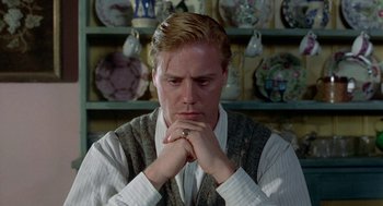 Movie still from “Carrington” (1995), directed by Christopher Hampton – A person with his hands clasped together; Close Up shot, Low angle