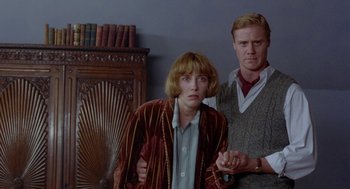 Movie still from “Carrington” (1995), directed by Christopher Hampton – A man and a woman standing next to each other in a room; Medium shot, Low angle