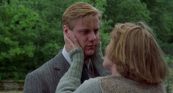 Movie still from “Carrington” (1995), directed by Christopher Hampton – A man and a woman touching each other's ears; Close Up shot, Low angle