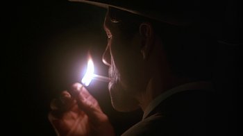 Movie still from “Cast a Deadly Spell” (1991), directed by Martin Campbell – A man is lighting a cigarette in the dark; Close Up shot, Low angle