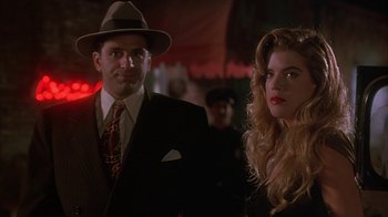 Movie still from “Cast a Deadly Spell” (1991), directed by Martin Campbell – A man and a woman standing next to each other; Close Up shot, Low angle