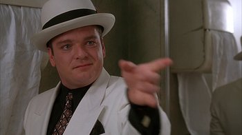 Movie still from “Cast a Deadly Spell” (1991), directed by Martin Campbell – A man wearing a white hat and a white jacket; Close Up shot, Low angle