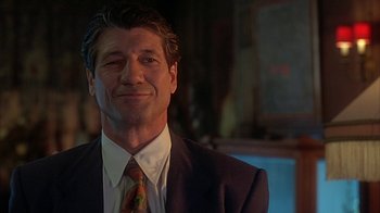 Movie still from “Cast a Deadly Spell” (1991), directed by Martin Campbell – A person wearing a suit and tie; Close Up shot, Low angle