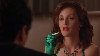 Movie still from “Cast a Deadly Spell” (1991), directed by Martin Campbell – A woman smoking a cigarette in front of a mirror; Close Up shot, Over the shoulder angle