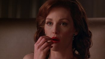Movie still from “Cast a Deadly Spell” (1991), directed by Martin Campbell – A person holding a cigarette holder up to their mouth; Close Up shot, Low angle