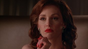 Movie still from “Cast a Deadly Spell” (1991), directed by Martin Campbell – A woman with red lipstick is holding her hand up to her face; Close Up shot, Low angle