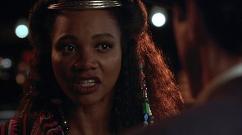 Movie still from “Cast a Deadly Spell” (1991), directed by Martin Campbell – A person wearing a crown; Close Up shot, Over the shoulder angle