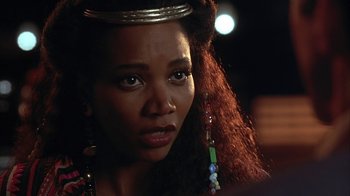 Movie still from “Cast a Deadly Spell” (1991), directed by Martin Campbell – A person wearing a crown; Close Up shot, Over the shoulder angle
