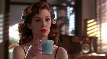 Movie still from “Cast a Deadly Spell” (1991), directed by Martin Campbell – A beautiful woman holding a cup of coffee; Close Up shot, Low angle
