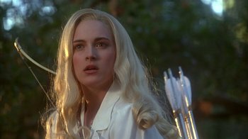 Movie still from “Cast a Deadly Spell” (1991), directed by Martin Campbell – A woman with long blonde hair is holding an arrow; Close Up shot, Over the shoulder angle