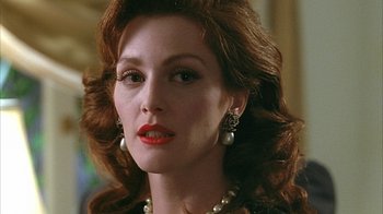 Movie still from “Cast a Deadly Spell” (1991), directed by Martin Campbell – A person wearing a necklace and earrings; Close Up shot, Over the shoulder angle