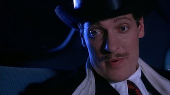 Movie still from “Cast a Deadly Spell” (1991), directed by Martin Campbell – A person wearing a top hat; Close Up shot, Low angle