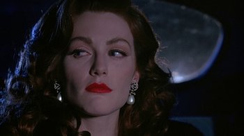Movie still from “Cast a Deadly Spell” (1991), directed by Martin Campbell – A person with red lipstick; Close Up shot, Over the shoulder angle