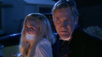 Movie still from “Cast a Deadly Spell” (1991), directed by Martin Campbell – A man and a woman with their mouths taped shut; Close Up shot, Low angle