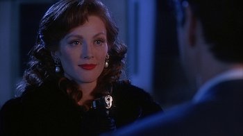 Movie still from “Cast a Deadly Spell” (1991), directed by Martin Campbell – A person wearing a black jacket; Close Up shot, Over the shoulder angle