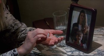 Movie still from “Castle Freak” (1995), directed by Stuart Gordon – A person is holding a pill bottle in their hand; Extreme Close Up shot, High angle