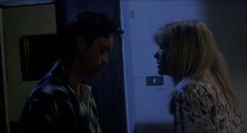 Movie still from “Castle Freak” (1995), directed by Stuart Gordon – A man and a woman standing next to each other in the dark; Close Up shot, Low angle