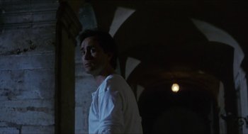 Movie still from “Castle Freak” (1995), directed by Stuart Gordon – A man standing in the dark looking up at the sky; Medium shot, Low angle