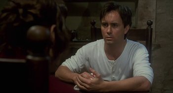 Movie still from “Castle Freak” (1995), directed by Stuart Gordon – A man sitting in front of a mirror looking at himself in the mirror; Close Up shot, Over the shoulder angle