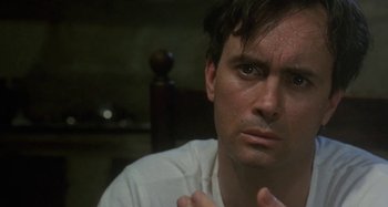 Movie still from “Castle Freak” (1995), directed by Stuart Gordon – A person with his hands crossed; Close Up shot, Low angle