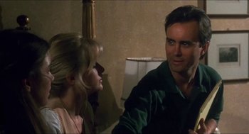 Movie still from “Castle Freak” (1995), directed by Stuart Gordon – A man and a woman sitting in front of each other in a room; Close Up shot, Low angle