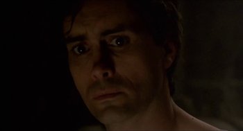 Movie still from “Castle Freak” (1995), directed by Stuart Gordon – A person looking at the camera; Close Up shot, Low angle