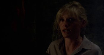 Movie still from “Castle Freak” (1995), directed by Stuart Gordon – A woman with blonde long hair is looking into the camera; Close Up shot, Over the shoulder angle