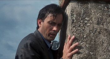 Movie still from “Castle Freak” (1995), directed by Stuart Gordon – A man leaning against a wall with his hand on his face; Close Up shot, Low angle