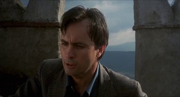 Movie still from “Castle Freak” (1995), directed by Stuart Gordon – A person wearing a suit and tie; Close Up shot, Low angle