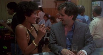 Movie still from “Castle Freak” (1995), directed by Stuart Gordon – A man and a woman sitting at a table in front of each other; Medium shot, Low angle