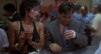 Movie still from “Castle Freak” (1995), directed by Stuart Gordon – A man and a woman sitting at a table with drinks; Medium shot, Low angle