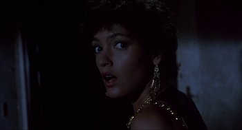 Movie still from “Castle Freak” (1995), directed by Stuart Gordon – A person wearing a necklace; Close Up shot, Low angle
