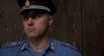 Movie still from “Castle Freak” (1995), directed by Stuart Gordon – A person wearing a uniform; Close Up shot, Low angle