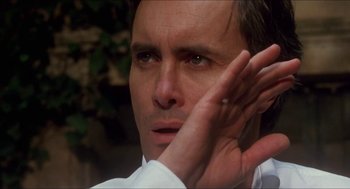 Movie still from “Castle Freak” (1995), directed by Stuart Gordon – A person with his hand up to his ear; Close Up shot, Low angle