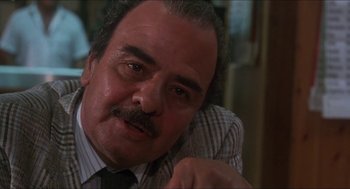 Movie still from “Castle Freak” (1995), directed by Stuart Gordon – An older man wearing a tie and a striped shirt; Close Up shot, Low angle