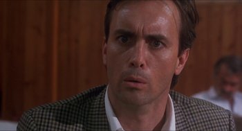 Movie still from “Castle Freak” (1995), directed by Stuart Gordon – A person wearing a suit and tie; Close Up shot, Low angle