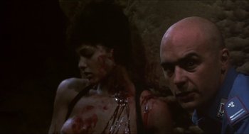 Movie still from “Castle Freak” (1995), directed by Stuart Gordon – A man and a woman are covered in blood; Close Up shot, Low angle