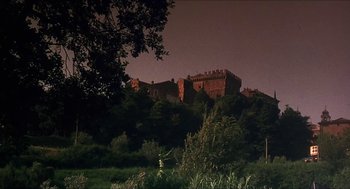 Movie still from “Castle Freak” (1995), directed by Stuart Gordon – A large castle on top of a hill at night; Extreme Wide shot, Low angle