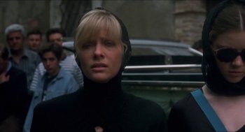 Movie still from “Castle Freak” (1995), directed by Stuart Gordon – A woman in a black jacket and a black head scarf; Close Up shot, Low angle