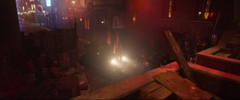 Movie still from “Cats” (2019), directed by Tom Hooper – A car parked on the side of the road at night; Extreme Wide shot, High angle