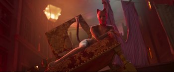 Movie still from “Cats” (2019), directed by Tom Hooper – A woman in a cat costume sitting on a chair; Wide shot, High angle