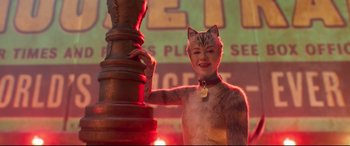 Movie still from “Cats” (2019), directed by Tom Hooper – A woman in a cat costume standing next to a lamp post; Medium shot, Low angle