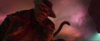 Movie still from “Cats” (2019), directed by Tom Hooper – A man in a hat and a fur coat holding a cat; Close Up shot, Low angle
