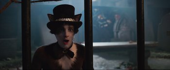 Movie still from “Cats” (2019), directed by Tom Hooper – A person wearing a cat costume and a top hat; Close Up shot, Over the shoulder angle