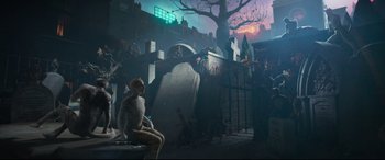 Movie still from “Cats” (2019), directed by Tom Hooper – A man sitting on a bench in front of a grave yard; Wide shot, High angle