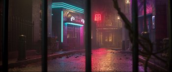Movie still from “Cats” (2019), directed by Tom Hooper – A city street with a red light at night time; Extreme Wide shot, High angle