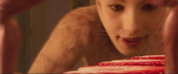 Movie still from “Cats” (2019), directed by Tom Hooper – A cat's face and its fur on a table; Extreme Close Up shot, High angle